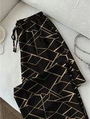 Calça Feminina Geométrica — Ajuste Confortável — Cintura com Faixa e Estampa Color Block